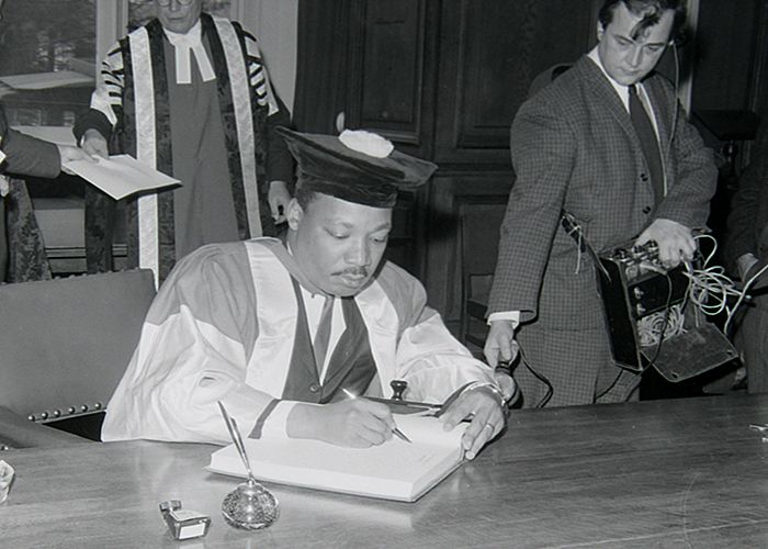 Martin Luther King signing the University's visitors' book