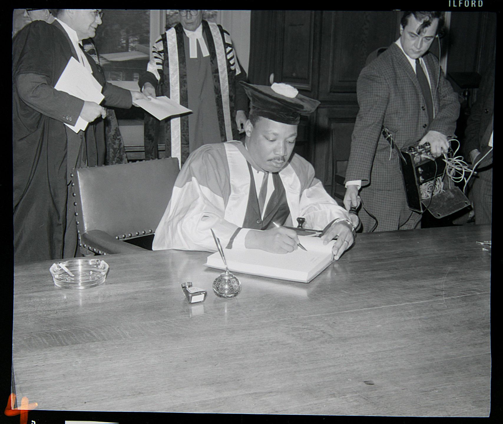 Martin Luther King signing the University's visitors' book 