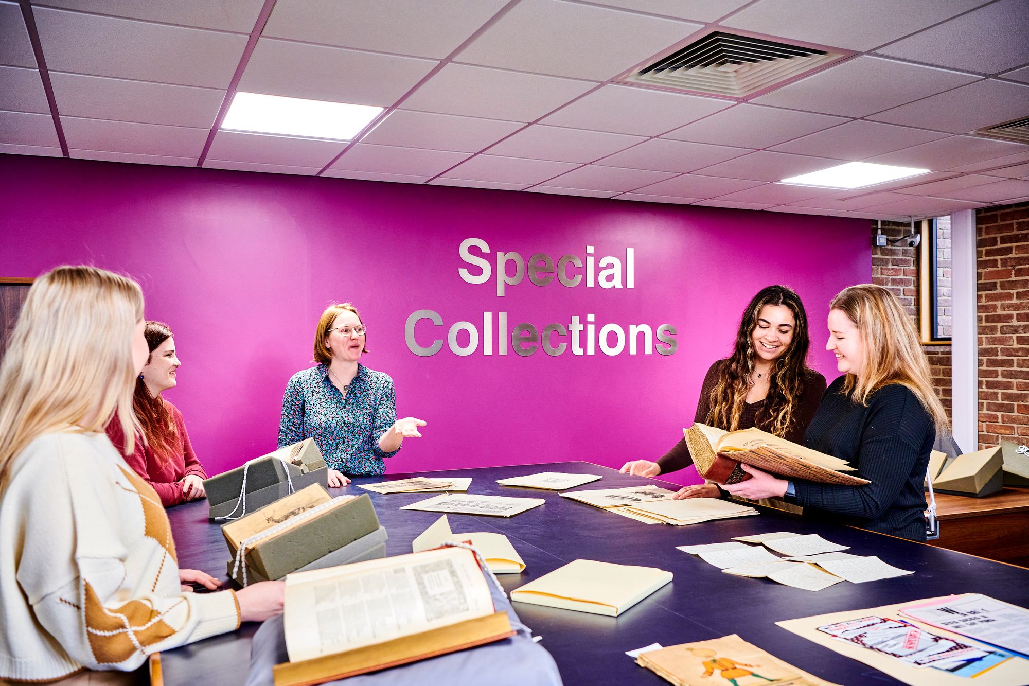 Photograph of a teaching session with material on display from Newcastle University Special Collections & Archives