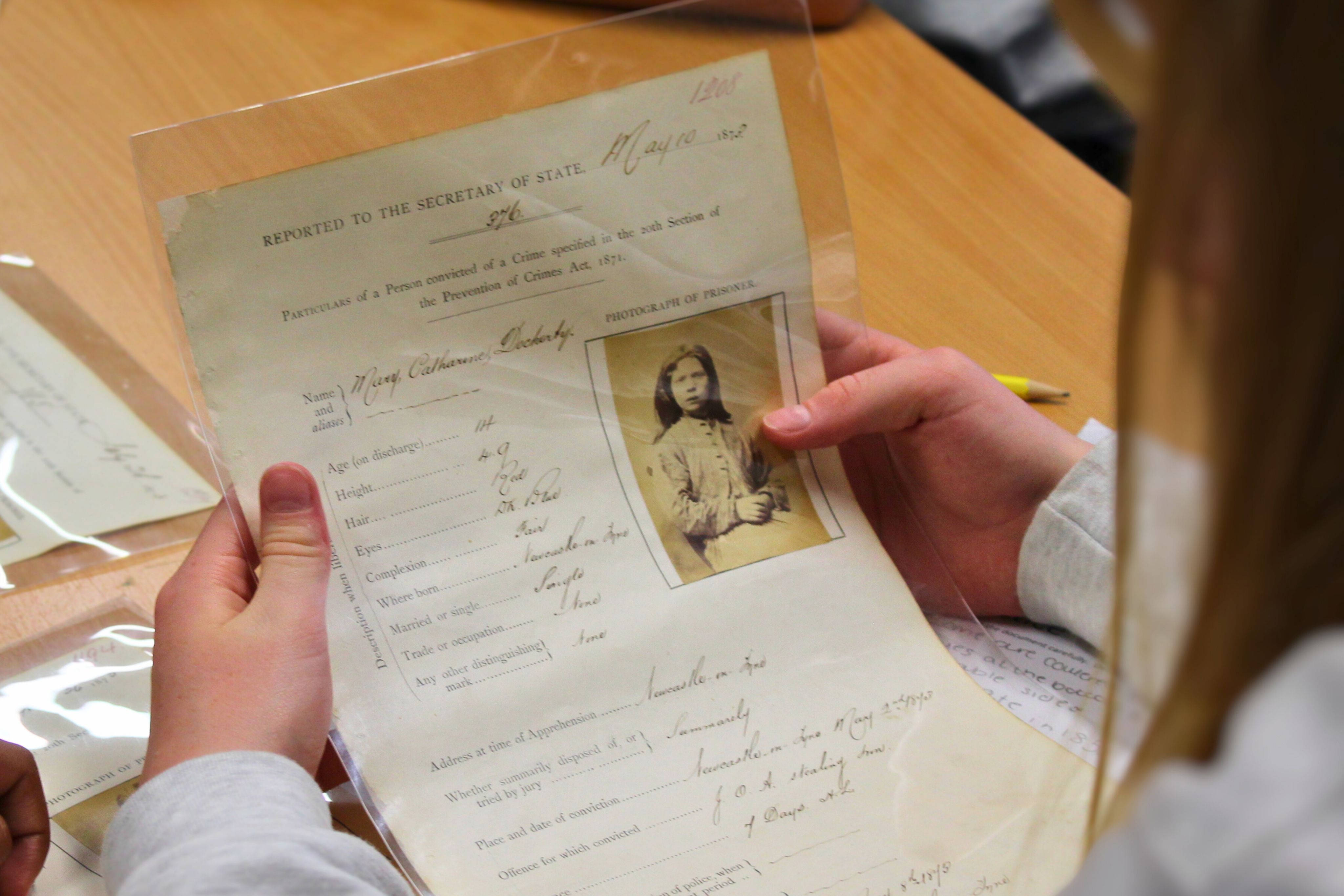 Hands holding a criminal record on an A4 sheet