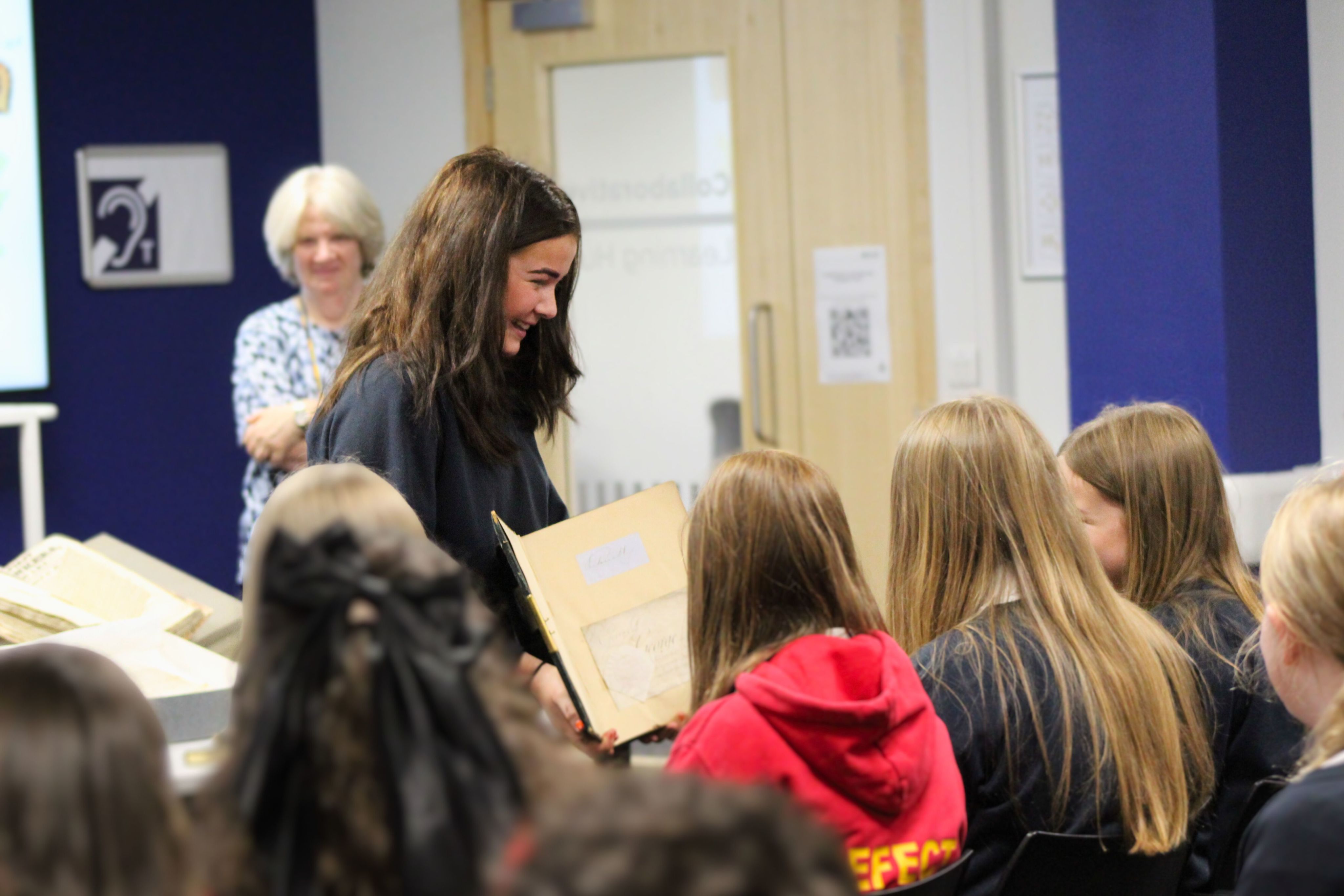 A student holding a book open