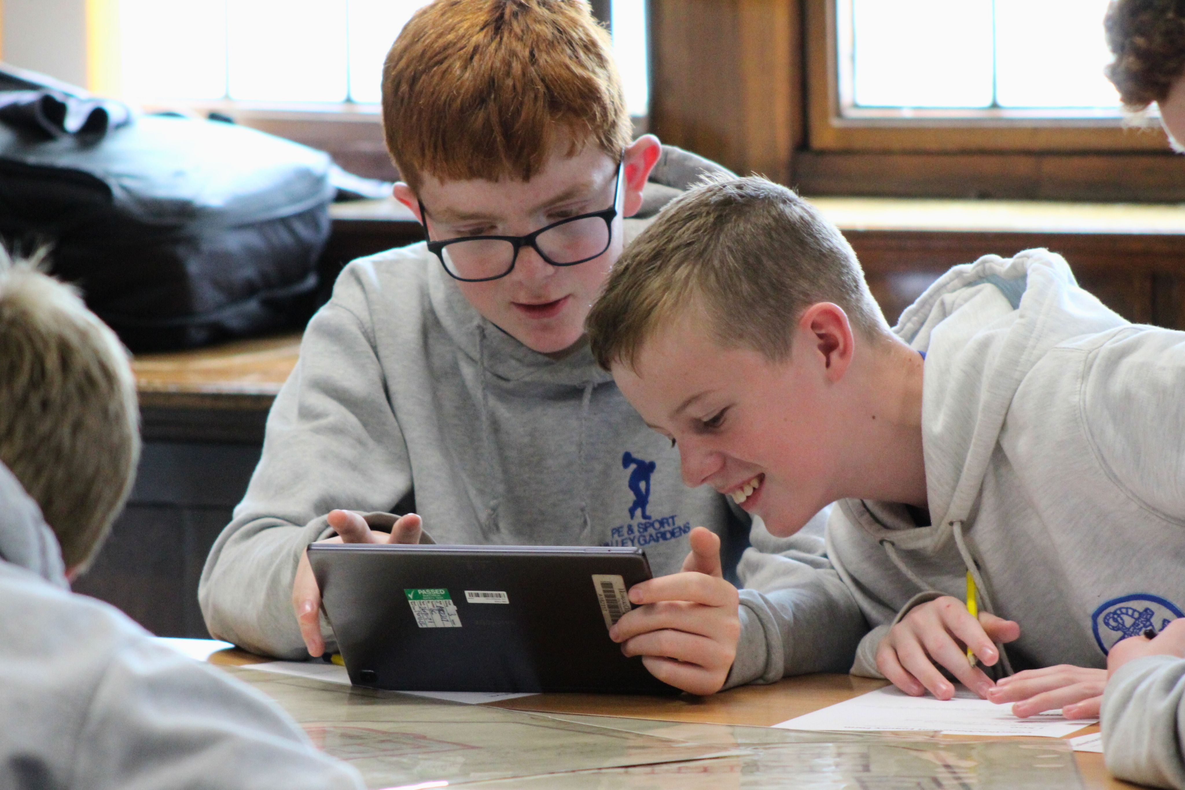 Two students looking at a tablet