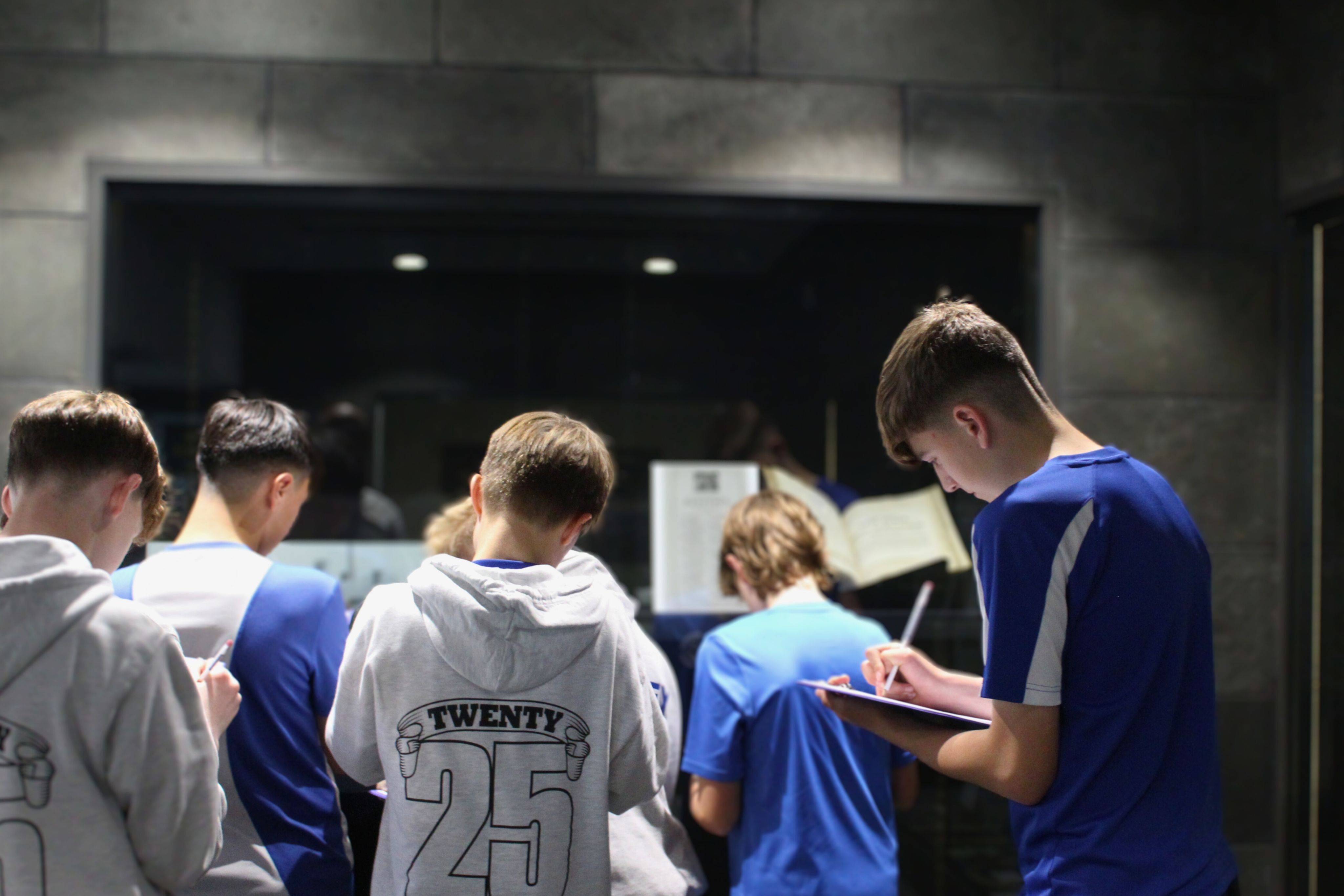 Students taking notes in front of an exhibition