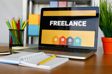 A laptop screen displays a page that says 'FREELANCE'