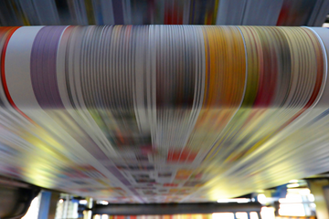 Close up, low shutter-speed shot of a modern printing press.