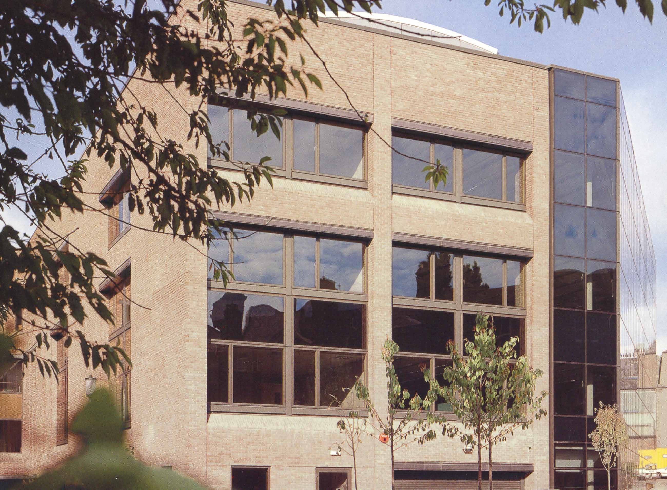 Exterior photograph showing the extension with large windows. 