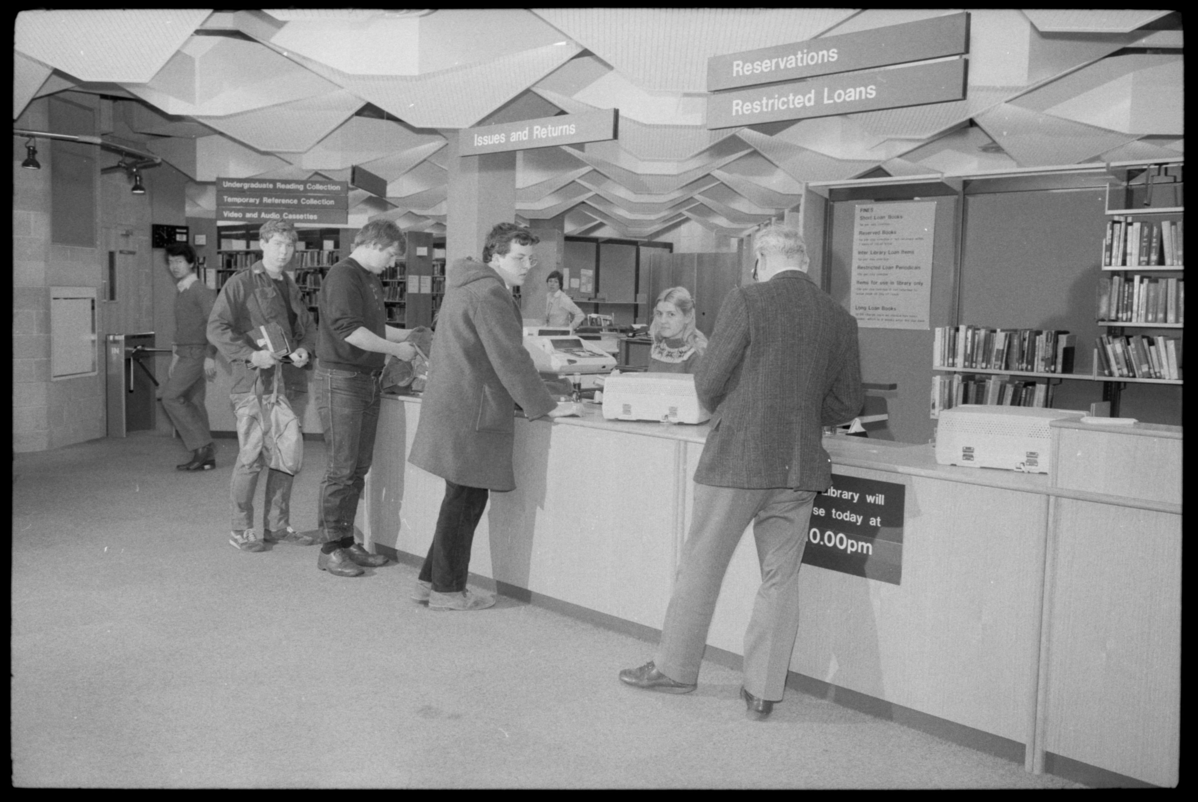 Photograph of students queuing inside the New Library, opens 1982. NUA/A/159928/10.