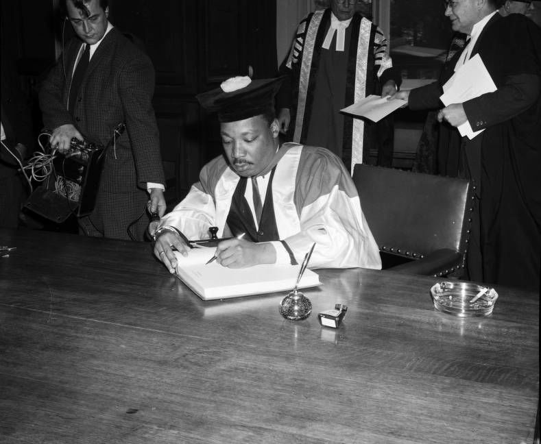 Photograph of Martin Luther King signing the University's visitors' book, 1967. NUA/052589/04.