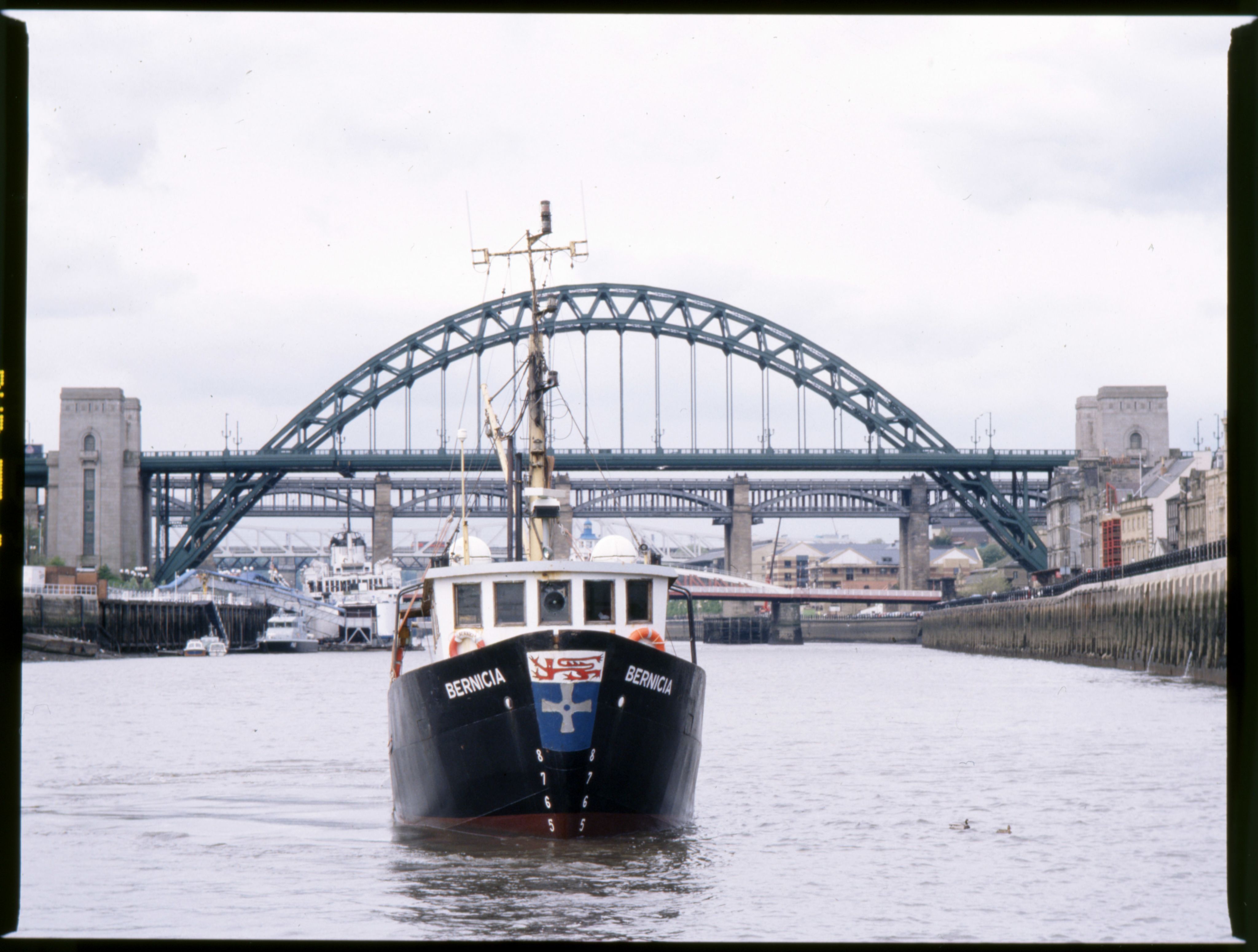 Photograph of research boat ‘Bernicia’, launched 1973. Pictured here in front of the Tyne Bridge. NUA/CN/281460/01.