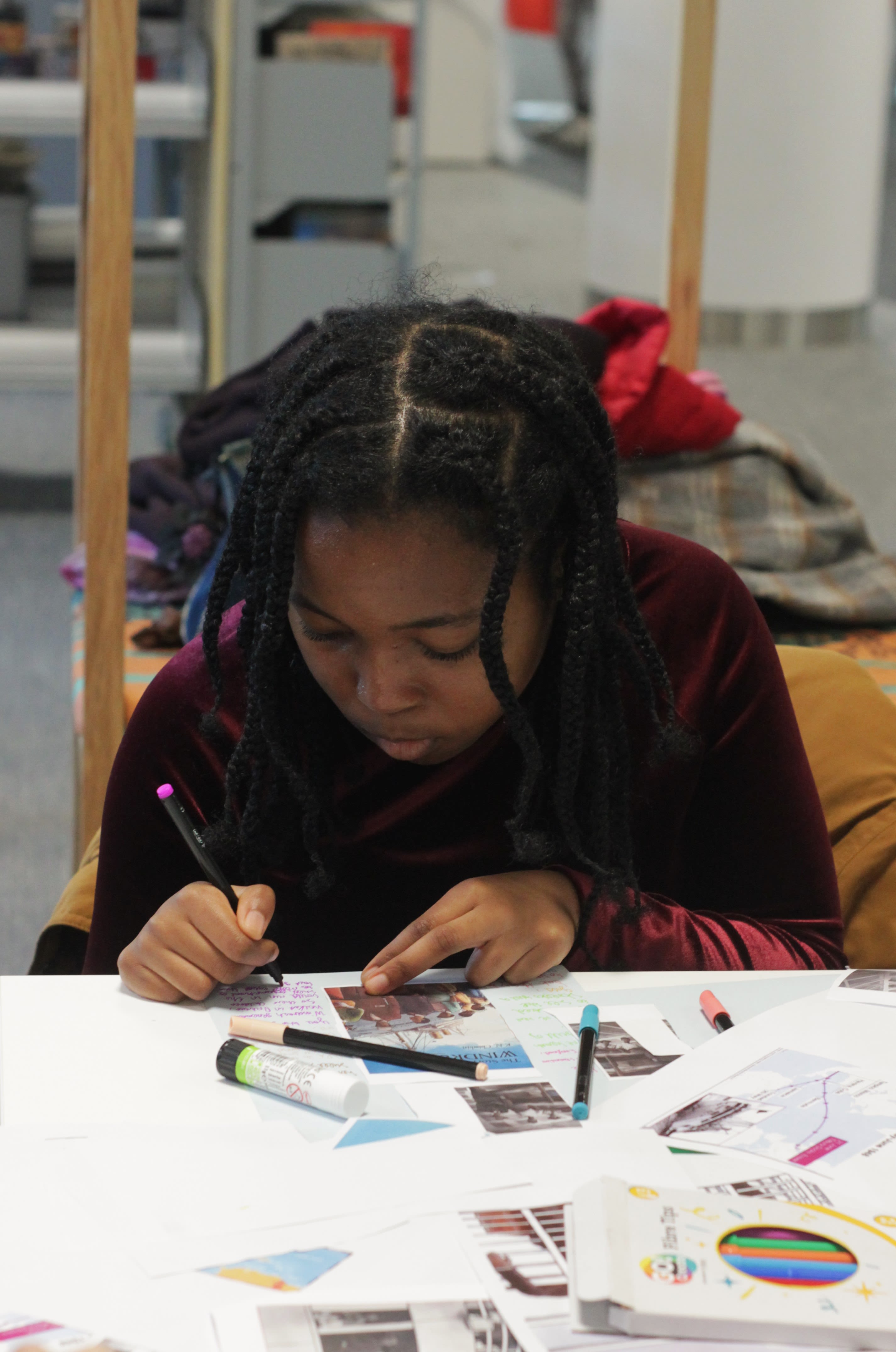 Image of a girl holding a pen and looking down